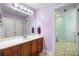Well-maintained bathroom featuring a large mirror, wood vanity, and a doorway leading to a separate toilet room at 3706 Song Sparrow Dr, Matthews, NC 28104