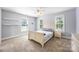 Inviting bedroom featuring neutral walls, carpet flooring, and two windows that provide ample natural light at 3706 Song Sparrow Dr, Matthews, NC 28104