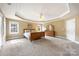 Bright bedroom featuring neutral walls, plush carpeting, a ceiling fan, and a large window for ample natural light at 3706 Song Sparrow Dr, Matthews, NC 28104