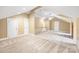 Large bonus room with neutral paint, and carpet, and multiple doors leading to other spaces at 3706 Song Sparrow Dr, Matthews, NC 28104