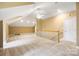 Spacious bonus room with vaulted ceilings, carpet, and a railing overlooking another part of the home at 3706 Song Sparrow Dr, Matthews, NC 28104