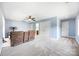 The light blue bonus room features neutral carpet, a ceiling fan, and multiple doors and closets at 3706 Song Sparrow Dr, Matthews, NC 28104