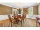 Formal dining room with hardwood floors, chandelier, and wainscoting at 3706 Song Sparrow Dr, Matthews, NC 28104