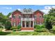 Charming brick home with white balcony and manicured landscaping at 3706 Song Sparrow Dr, Matthews, NC 28104
