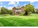 Beautiful brick home with manicured lawn and mature trees at 3706 Song Sparrow Dr, Matthews, NC 28104