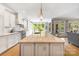 Spacious kitchen with large island, white cabinetry, and modern lighting at 3706 Song Sparrow Dr, Matthews, NC 28104