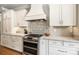 Close up of the gourmet kitchen with stainless steel range and custom cabinetry at 3706 Song Sparrow Dr, Matthews, NC 28104