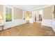Bright living room with hardwood floors, white trim, and large windows at 3706 Song Sparrow Dr, Matthews, NC 28104
