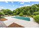 Inviting in-ground pool surrounded by lush landscaping and a spacious pool deck for relaxation at 3706 Song Sparrow Dr, Matthews, NC 28104