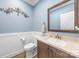 Well-appointed powder room with a vanity, mirror, and decorative accents at 3706 Song Sparrow Dr, Matthews, NC 28104
