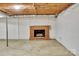 This basement features a brick fireplace with log storage at 37156 Southside Rd, Albemarle, NC 28001