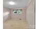 This is a small bedroom with a single window and neutral carpet at 37156 Southside Rd, Albemarle, NC 28001