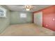 Well-lit bedroom with a ceiling fan and double closet doors at 37156 Southside Rd, Albemarle, NC 28001