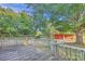 Backyard deck overlooking a lush lawn with mature trees and distant barn structures, with a country view at 37156 Southside Rd, Albemarle, NC 28001