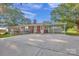 Charming brick home with a covered carport, spacious driveway, and well-maintained landscaping at 37156 Southside Rd, Albemarle, NC 28001