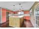 Kitchen with custom island, open cabinetry, and sleek flooring at 37156 Southside Rd, Albemarle, NC 28001