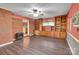Inviting living room features a brick accent wall and custom built-in shelving at 37156 Southside Rd, Albemarle, NC 28001