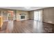 Spacious living room with exposed brick fireplace and sliding glass doors at 37156 Southside Rd, Albemarle, NC 28001