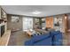 Virtual staging shows open living area with fireplace and access to deck at 37156 Southside Rd, Albemarle, NC 28001