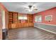 Spacious living room with custom built-in shelving, ceiling fan, and wainscoting at 37156 Southside Rd, Albemarle, NC 28001