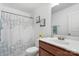 Bathroom with wooden vanity, framed mirror, and shower with patterned curtain at 3735 Ernie Dr, Charlotte, NC 28269