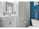 Clean, white bathroom featuring a vanity with storage, toilet, and decorative wall art at 3735 Ernie Dr, Charlotte, NC 28269