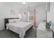 Bright bedroom with grey bed frame, pink accents, and natural light from the window at 3735 Ernie Dr, Charlotte, NC 28269