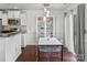 Charming dining area featuring modern lighting, a stylish table, and an adjacent kitchen space at 3735 Ernie Dr, Charlotte, NC 28269