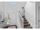 Bright foyer showcasing hardwood floors, a staircase, and a decorative mirror at 3735 Ernie Dr, Charlotte, NC 28269
