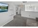 Second floor hallway with gray carpet and modern light fixtures leading to multiple bedrooms at 3735 Ernie Dr, Charlotte, NC 28269