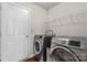 Efficient laundry room with modern washer and dryer set and wire rack shelving at 3735 Ernie Dr, Charlotte, NC 28269
