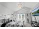 Bright main bedroom with vaulted ceiling, neutral decor, ensuite bathroom and large television at 3735 Ernie Dr, Charlotte, NC 28269