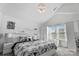 Bright main bedroom with vaulted ceiling, neutral decor, and ensuite bathroom at 3735 Ernie Dr, Charlotte, NC 28269