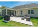 Rear exterior view featuring a screened in porch and stone patio with outdoor seating and a grill at 385 Willow Tree Dr, Rock Hill, SC 29732
