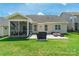 Rear exterior view showcasing a screened-in porch and stone patio perfect for outdoor relaxation and dining at 385 Willow Tree Dr, Rock Hill, SC 29732