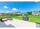 View of the back patio featuring outdoor seating, grill, and well-maintained lawn on a sunny day at 385 Willow Tree Dr, Rock Hill, SC 29732