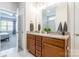 A well-lit bathroom with double sink vanity, granite countertop and stylish tile flooring at 385 Willow Tree Dr, Rock Hill, SC 29732