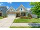 Charming two-story home with manicured lawn, brick accents, and a two-car garage at 385 Willow Tree Dr, Rock Hill, SC 29732