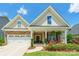 Charming home with a well-manicured lawn, stone accents, covered front porch, and bright landscaping at 385 Willow Tree Dr, Rock Hill, SC 29732