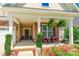 Inviting covered porch with brick columns, hanging ferns, and seating perfect for relaxing at 385 Willow Tree Dr, Rock Hill, SC 29732
