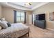 Bright main bedroom featuring a large window and a TV on the dresser at 385 Willow Tree Dr, Rock Hill, SC 29732
