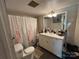 Functional bathroom featuring a vanity, toilet, and shower-tub combination with a shower curtain at 4059 10Th Avenue Sw Dr, Hickory, NC 28602