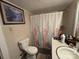 Cozy bathroom features a shower with floral curtain and tiled walls at 4059 10Th Avenue Sw Dr, Hickory, NC 28602