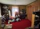 Bedroom with red carpet, wood paneled walls and a large collection of stuffed animals at 4059 10Th Avenue Sw Dr, Hickory, NC 28602