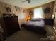 Comfortable bedroom with a queen-sized bed, soft lighting, and cozy decor at 4059 10Th Avenue Sw Dr, Hickory, NC 28602