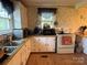 Bright kitchen featuring essential appliances, white cabinets, and natural light at 4059 10Th Avenue Sw Dr, Hickory, NC 28602