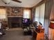 Living room with a brick fireplace, neutral carpet and paneled walls at 4059 10Th Avenue Sw Dr, Hickory, NC 28602