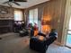 Living room with brick fireplace, ceiling fan, and comfortable seating at 4059 10Th Avenue Sw Dr, Hickory, NC 28602