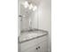 Bathroom vanity with granite countertop, white cabinets and an undermount sink at 443 Faith Sw Dr, Concord, NC 28027