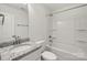 This bathroom features granite countertops, a modern sink, and a shower-tub combo with white tile at 443 Faith Sw Dr, Concord, NC 28027